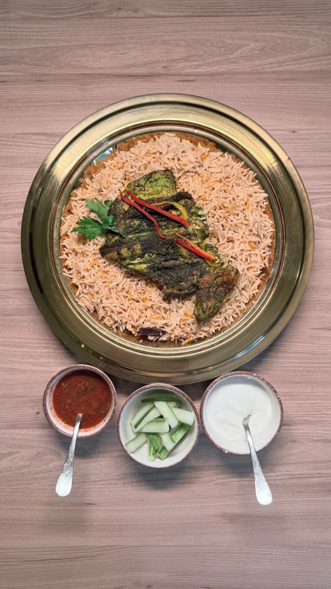 Green herb Al Faham on Mandhi rice on a brass tray